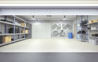 Open garage door with tools and shelves inside.