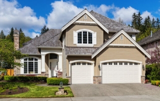 Photo of a modern suburban home exterior with new garage door that is boosting home value