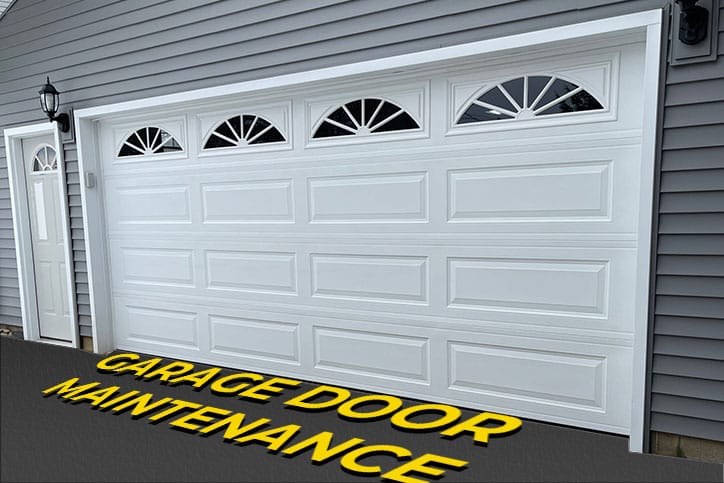 White Garage Door with text on Pavement saying Garage Door Maintenance